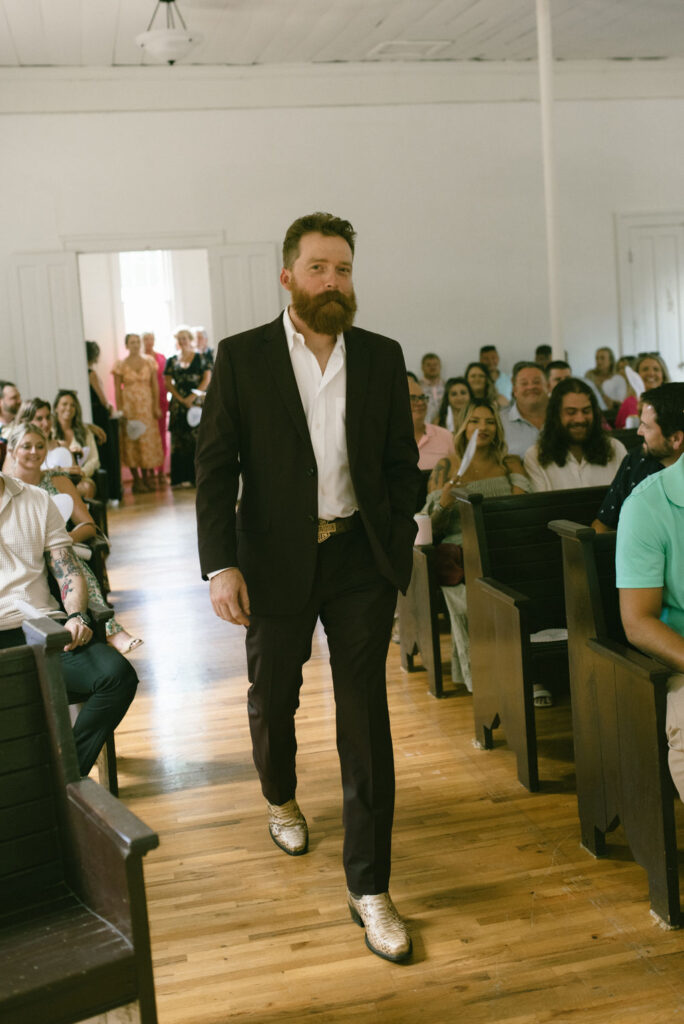 Groom walking down the isle 