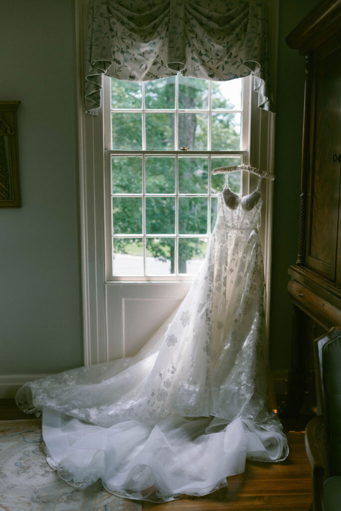 A Romantic Connecticut garden wedding wedding details and getting ready dress hanging in window