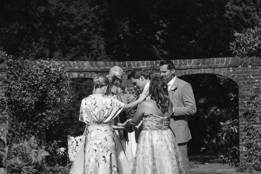 A Romantic Connecticut garden wedding first look down the aisle tear falling from groom's eye