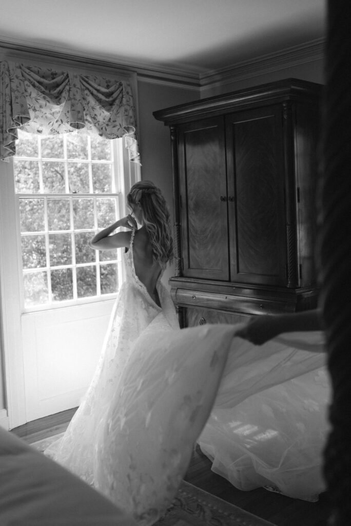 A Romantic Connecticut garden wedding wedding details and getting ready mom fluffing the bride's dress