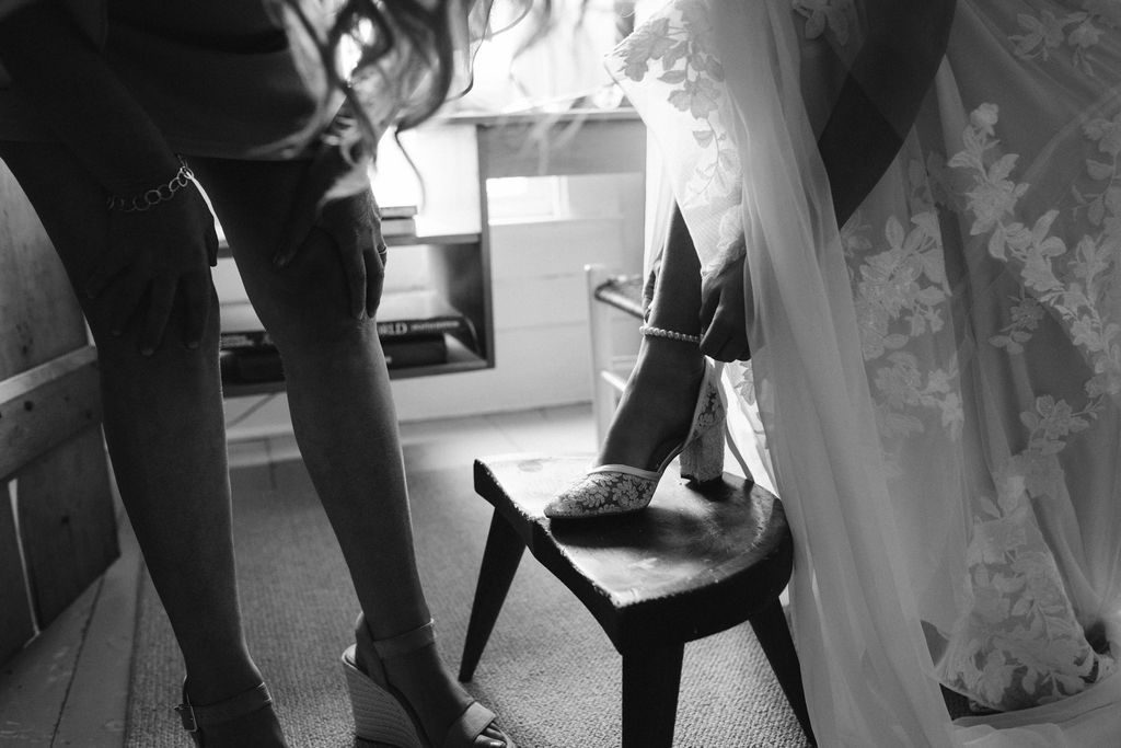 bride putting on shoes 