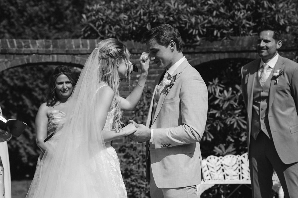 A Romantic Connecticut garden wedding first look down the aisle tear falling from groom's eye