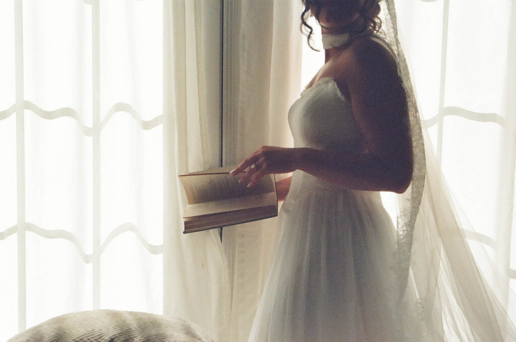 bride reading book at jane austen inspired intimate backyard wedding